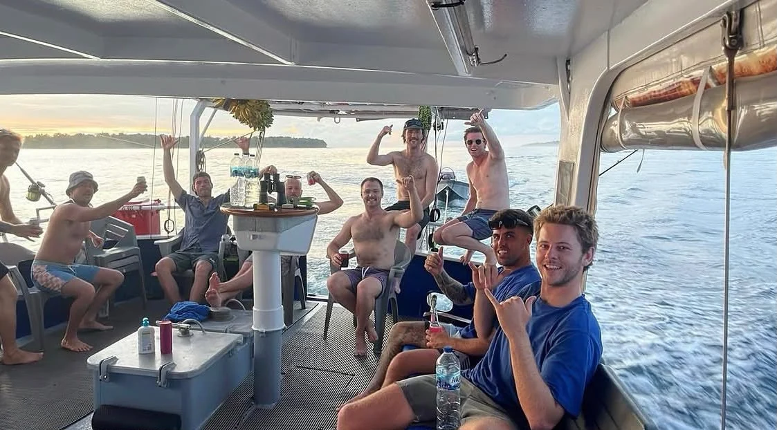 Happy Orca Laut guests sharing drinks together on deck