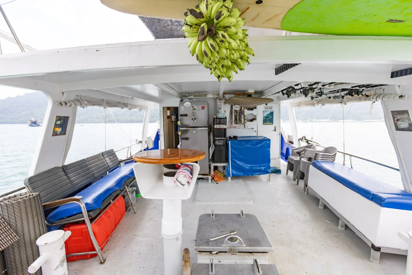 Shaded deck seating and a dining table aboard Orca Laut